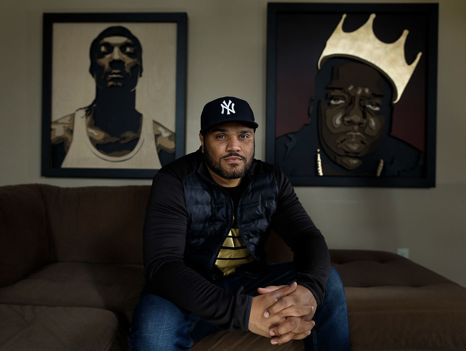 Portrait - 1st placePercy King, a former Ohio State football player, has been commissioned by the Columbus Museum of Art to create four three-dimensional wood portraits of important Columbus African American artists Aminah Robinson, Elijah Pierce, Kojo Kamau and William Hawkins. King poses for a photo in his house in Blacklick.(Kyle Robertson / The Columbus Dispatch)